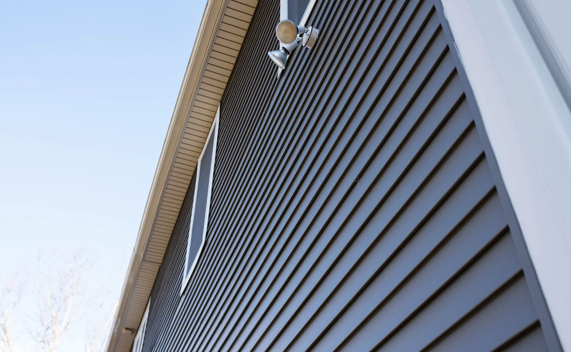 Low-angle view of horizontal siding panels on a Houston home